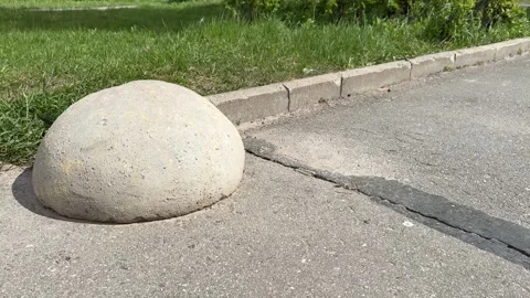 Yellow restrictive hemispheres on the asphalt road in the parking area of the Stock Footage 300054765