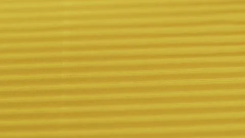 Yellow ribbed paper close-up. Macro shooting of cardboard textured background Видео 169237515