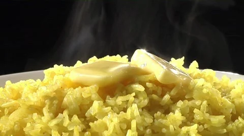 Yellow rice with knobs of butter Stock Footage 8574006