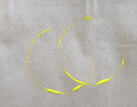 Yellow ring stain on paper background Stock Photos