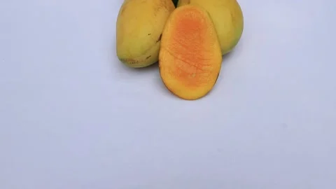 Yellow ripe mango piece slice with green mango leaf Video stock 195986823
