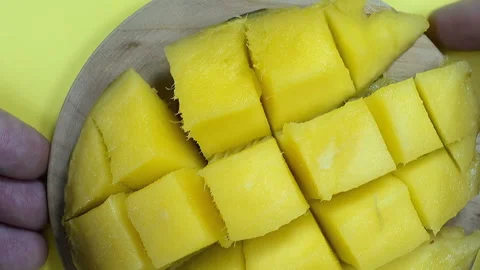 Yellow ripe pulp of mango fruit on a plate. Stock Footage 143134010