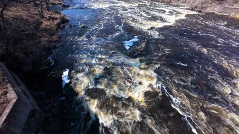 Yellow river below bridge Stock Footage 304808371