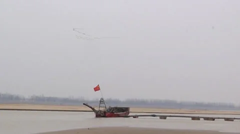 The yellow river, flowing peacefully in the winter, and the boat in a harbor Stock Footage 34882762
