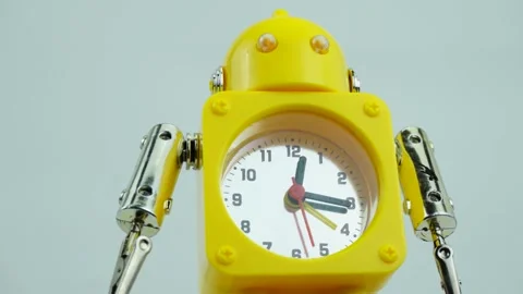 Yellow robotic clock lying on the table. Stock Footage 230114543