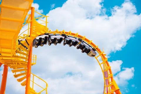 Yellow Roller coaster Roll loop curve high to blue sky summer season activi.. Foto stock