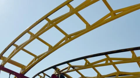 Yellow Roller Coaster Track Loops High Into the Bright Summer Sky Stock Footage 334035861