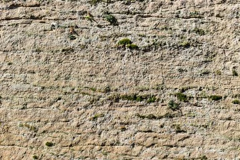 Yellow rough texture background wall bright broken cracked stone old surface Stock Photos