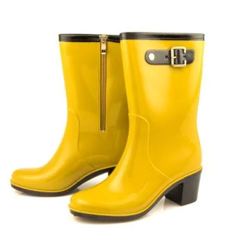 Yellow rubber boots Stock Photos