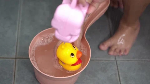 Yellow rubber duck is cleaned with shower water Stock Footage 231200000