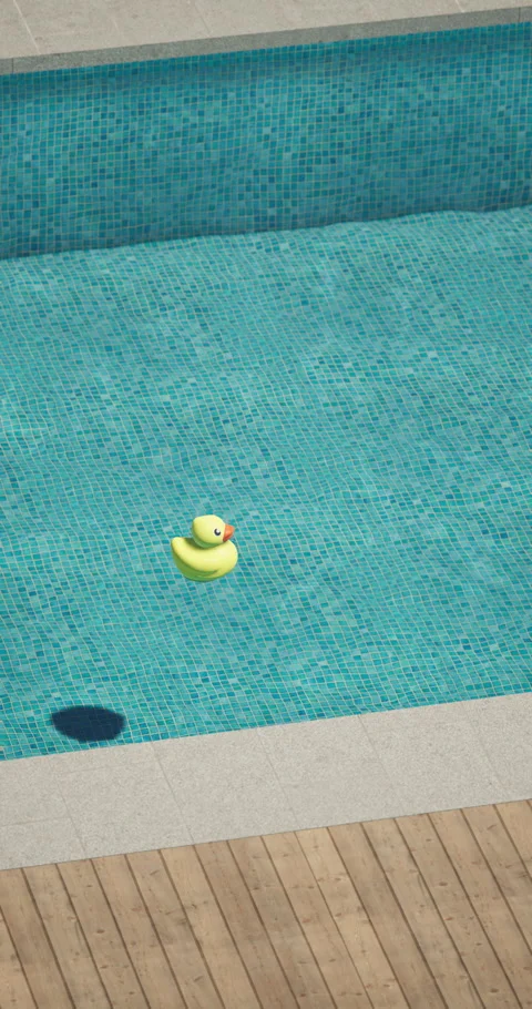 Yellow rubber duck floating in a clear blue swimming pool Stock Footage 312622292