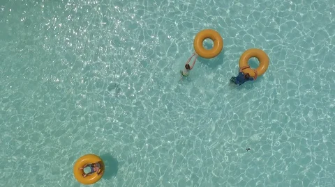 Yellow Rubber Ring in a swimming pool Stock Footage 90377176