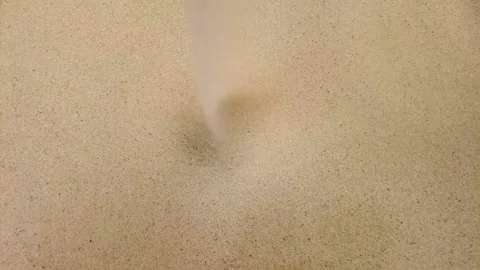 Yellow sand falling. Grains, sand of beach or dunes. Top view, motion closeup. Stock Footage 158353199