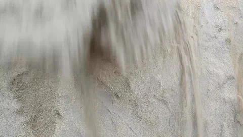 Yellow sand pours down the sand wall 스톡 동영상 203947044