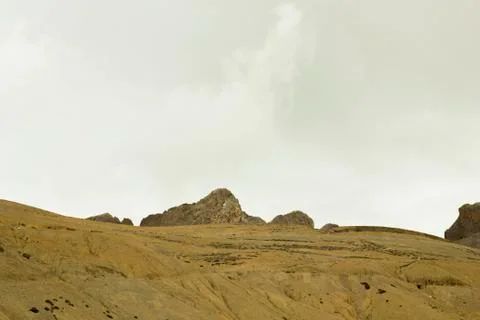 Yellow sandy mountain hills with rocks Stock Photos