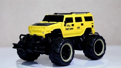 Yellow scale model SUV car with is rotating isolated on white background. Stock Footage 102961628