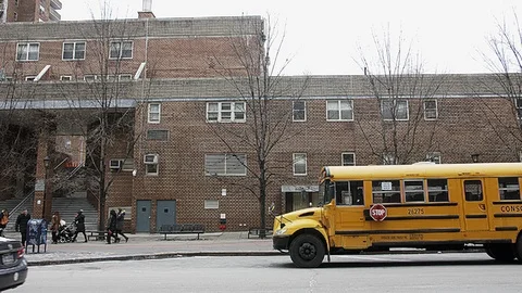 Yellow school bus in front of manhattan community college Video stock 92576959