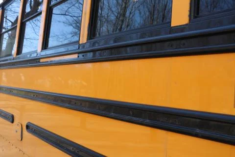 Yellow School Bus Side View on Sunny Day Stock Photos
