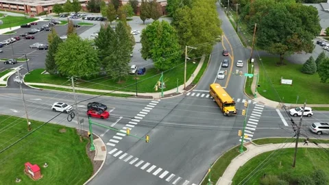 Yellow school buses at intersection in A... | Stock Video | Pond5