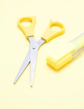 Yellow scissors and a marker Stock Photos