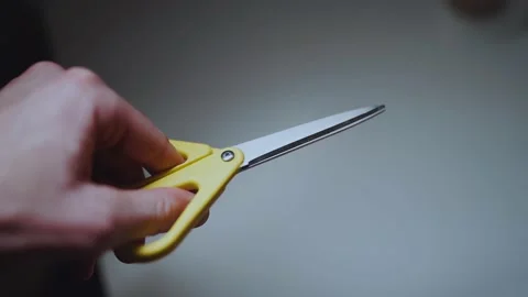 Yellow scissors in a man's hand Stock Footage 169663024