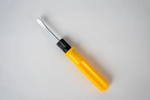 Yellow Screwdriver on White Surface Stock Photos
