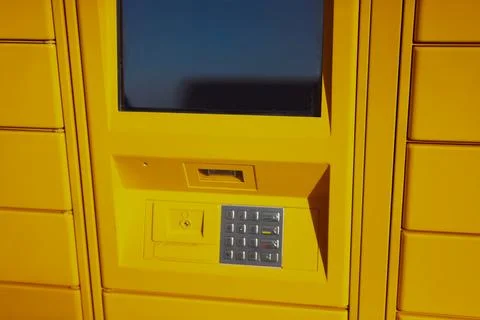 Yellow self-service package locker terminal offering secure mail and parcel.. 写真素材