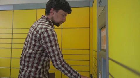 Yellow self-service postal terminal. Sending parcel. Parcel pick up point Stock Footage 276143908