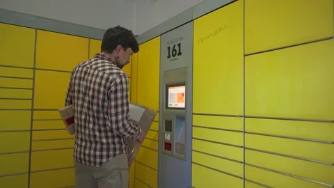 Yellow self-service postal terminal. Sending parcel. Parcel pick up point Stock Footage 280093487