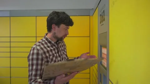 Yellow self-service postal terminal. Sending parcel. Parcel pick up point Stock Footage 329427985