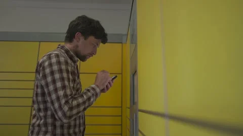 Yellow self-service postal terminal. Sending parcel. Parcel pick up point Stock-Footage 329428001