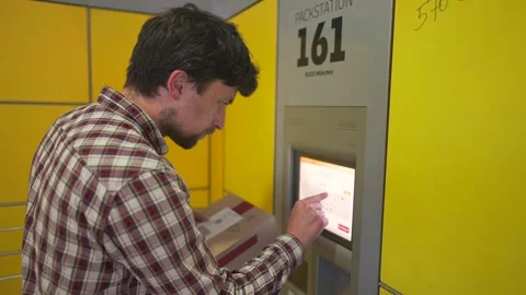 Yellow self-service postal terminal. Sending parcel. Parcel pick up point 스톡 동영상 329428700
