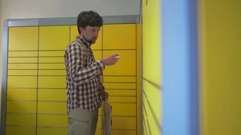 Yellow self-service postal terminal. Sending parcel. Parcel pick up point Stock Footage 329428870