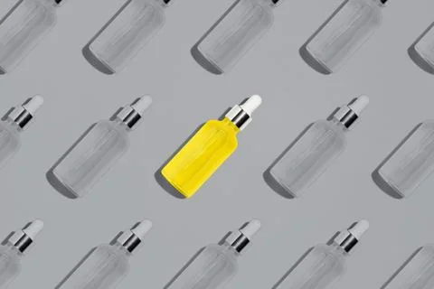 Yellow serum bottle pattern on gray background Stock Photos