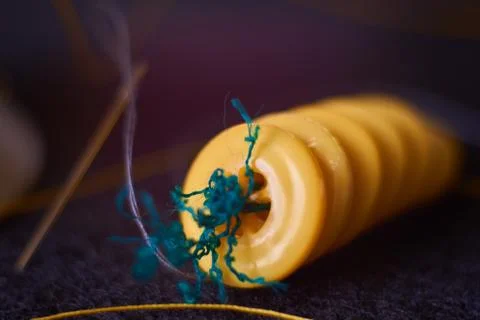 Yellow sewing buttons, needle with thread on needle punched nonw Stock Photos