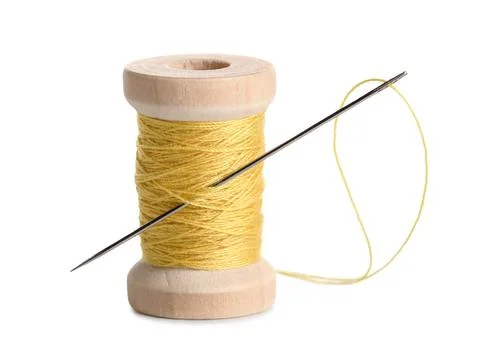 Yellow sewing thread with needle on white background Stock Photos