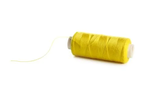 Yellow sewing thread on white background Stock Photos