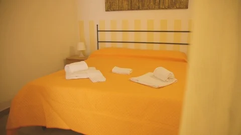 Yellow sheets bedroom with towels Stock Footage 86749088