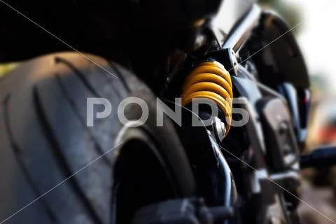 Yellow shock Absorber's motorcycle, de-focus Stock Photos