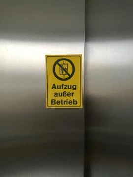 Yellow sign with the note Elevator Out of service German with Word Aufzug au er Stock-Fotos