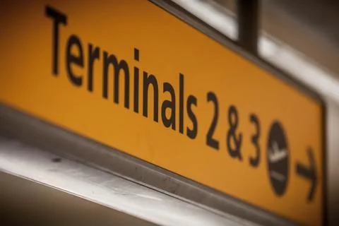 Yellow sign showing direction to terminal Stock Photos