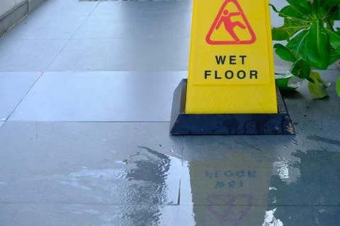 Yellow sign showing warning of caution wet floor Stock Photos