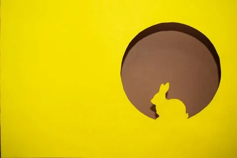 Yellow silhouette of an Easter bunny in a round window Stock Photos