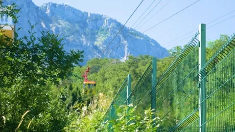 The yellow ski elevator descends from the mountains Stock Footage 246237934