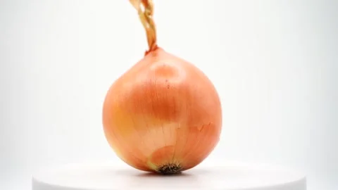 A yellow-skinned onion spins elegantly on a platform Stock Footage 289756789