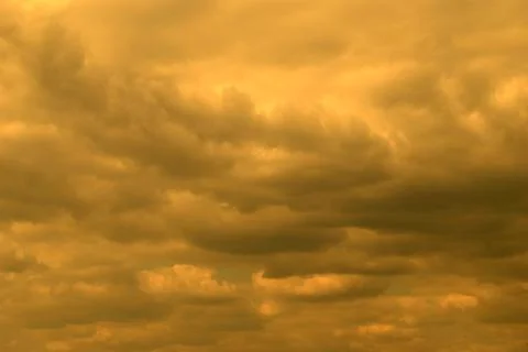Yellow sky gray clouds background Stock Photos