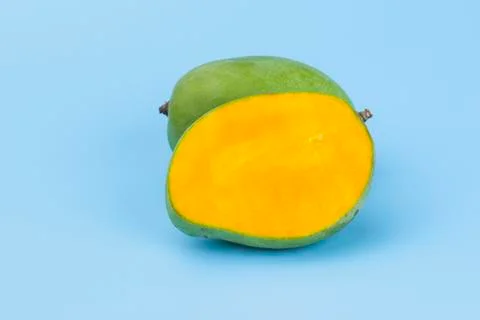 Yellow slice mango isolated on blue Stock Photos