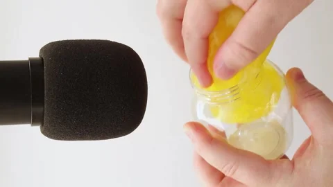 Yellow slime with pieces of cubes is put into a jar. Stock Footage 254802114