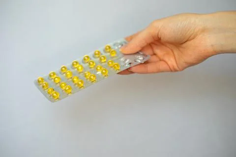 Yellow small round complex of vitamins and minerals Stock Photos
