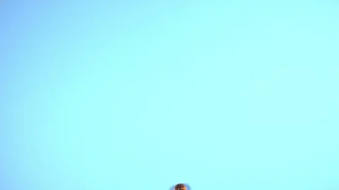 Yellow small transparent balls roll on a blue background Stock Footage 217896461